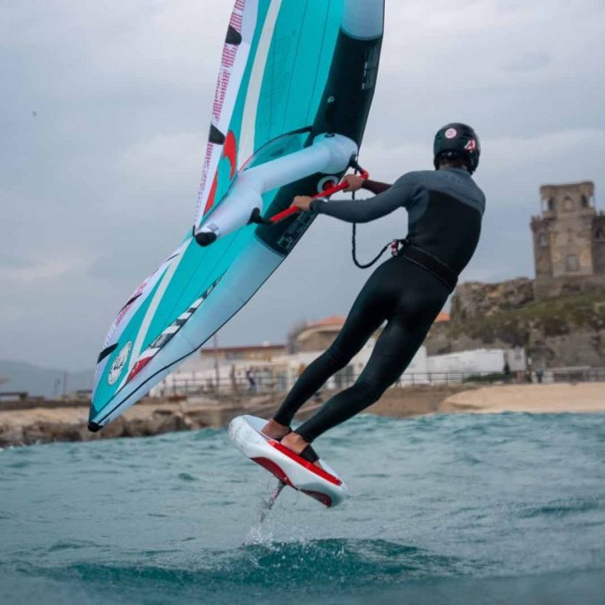 Vue latérale d'un rider pratiquant du wingfoil avec une Reedin Feather 2025 