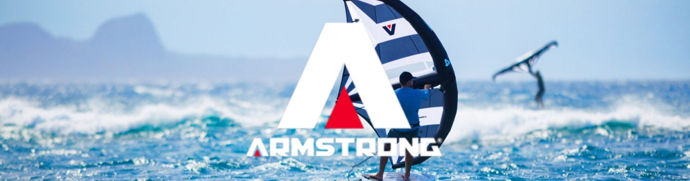 Bannière Armstrong : logo Armstrong au premier plan avec une aile de wingfoil Armstrong XPS en arrière-plan – le haut de gamme du wingfoil 2026
